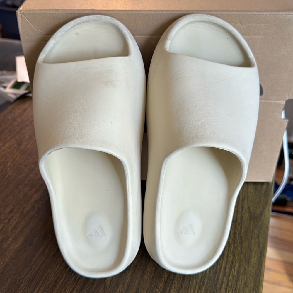 Beige Nike Yeezy slides, used with wear